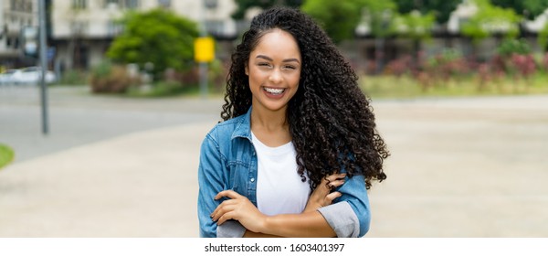 Brazilian Girl With Curly Hair And Braces And Copy Space Outdoor In Summer In City