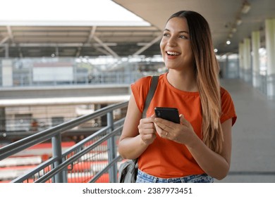 Brazilian girl walking in train station holding smartphone in Sao Paulo, Brazil - Powered by Shutterstock