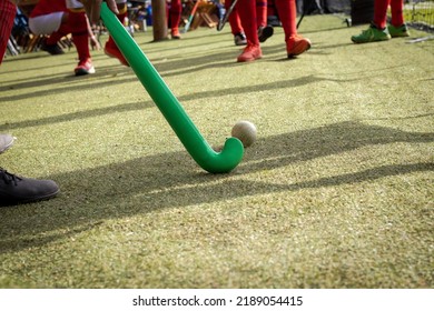 Brazilian grass hockey players warming up for the game on the field with sticks in their hands - Powered by Shutterstock