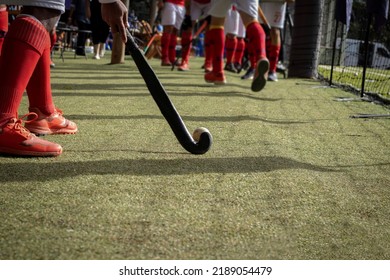 Brazilian grass hockey players warming up for the game on the field with sticks in their hands - Powered by Shutterstock