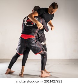 Brazilian jiu jistu bjj no-gi grappling training two male athletes drilling technique takedown wrestling - Powered by Shutterstock