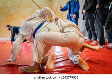 Brazilian jiu jitsu BJJ fighters working on the takedown or judo techniques at the training at academy wearing white kimono gi - Powered by Shutterstock