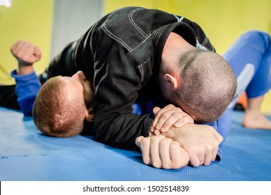 Brazilian Jiu Jitsu BJJ Jiujitsu Training Sparring Athlete Fighter Applying Americana Shoulder Lock Submission On His Opponent Technique Practice Side Control Position