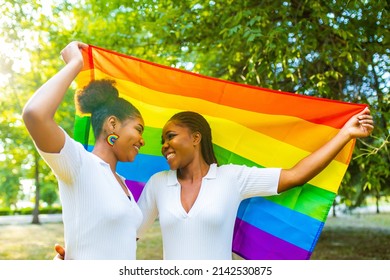 brazilian lesbian couple in white dress spending time together celebrating engagement in summer park outdoor