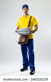 Brazilian mailman on a white background delivering a package. copy space.
