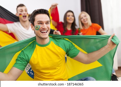 Brazilian Man With Friends From Different Country Enjoying The Soccer On TV