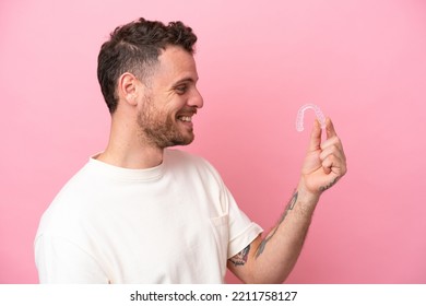 Brazilian Man Holding Invisible Braces With Happy Expression