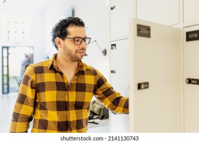 Brazilian Man Keeps His Backpacks In A Coworking Office Locker. Man Arriving At Work.