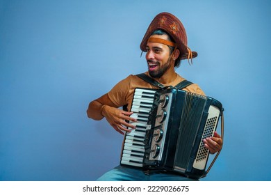 A Brazilian man playing Accordion with a tradicional hat. Tocando Sanfona. Festa junina. Tradiç˜ão Nordestina.