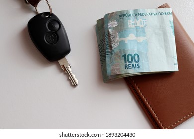 Brazilian Money, Wallet And Car Key On White Background. Car Payment Concept.