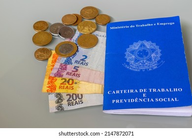 Brazilian Money, Work Card And Coins. Income Tax. Declaration. Translation: Work Card And Social Security, In Portuguese