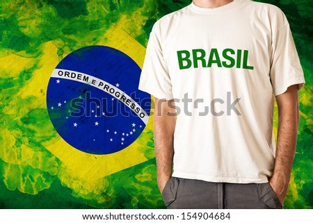 Brazilian national team supporter. Man in white shirt with BRASIL title and Brazil flag in background Stock photo © 
