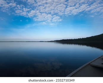 Brazilian Pantanal: Serene river, forested mountains, fishing boat, sun rays. Behold the captivating allure of the Pantanal, Brazil's natural gentle rays of the sun river reflecting. tranquility. - Powered by Shutterstock