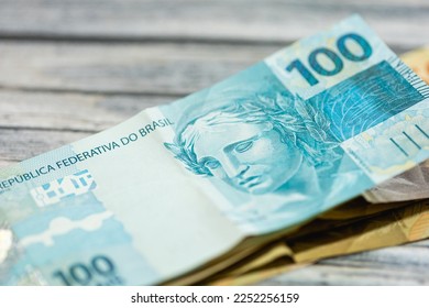 Brazilian Real banknotes on a wooden table in closeup photography.
 - Shutterstock ID 2252256159