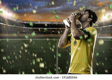 Brazilian soccer player, celebrating the championship with a trophy in his hand. - Powered by Shutterstock