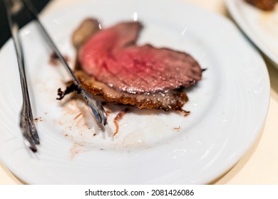 Brazilian Steakhouse Restaurant Table White Plate With Tongs In Churrascaria Serving Rodizio Style Barbecued Meats Steaks With Famous Picanha Top Sirloin Medium-rare Cut