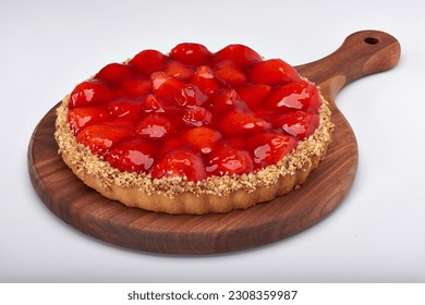 Brazilian strawberry pie on a round granite board on white background for clipping mask