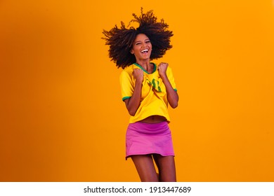 Brazilian Supporter. Brazilian Woman Fan Celebrating On Soccer Or Football Match On Yellow Background. Brazil Colors.
