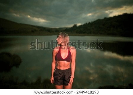 Brazilian woman athlete runner with a lake in the background