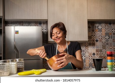 Brazilian Woman Cooking In Kitchen With Utensils