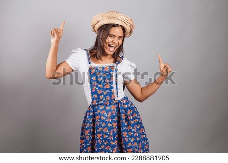 Brazilian woman wearing country clothes, São João party, Junina party. Dancing.