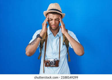 Brazilian Young Man Holding Vintage Camera With Hand On Head For Pain In Head Because Stress. Suffering Migraine. 