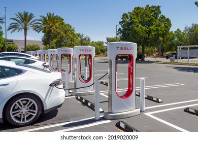 Brea, CA, USA – August 1, 2021: A white Tesla charging at Tesla Supercharger Station at the Brea Mall in Brea, California.  