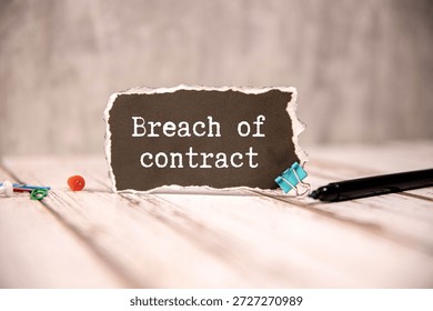BREACH OF CONTRACT. text in notepad next to glasses on white background