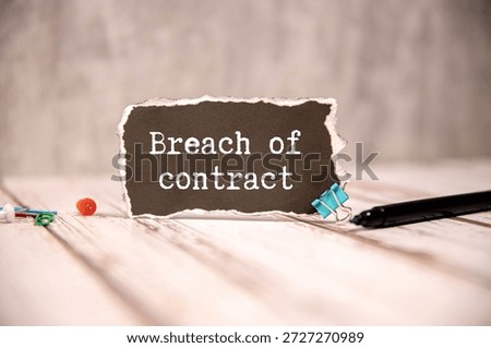 BREACH OF CONTRACT. text in notepad next to glasses on white background