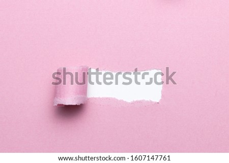 Breach or peeled of paper for hidden text used as template or mockup on pink natural paper, use for compositions and easy to color