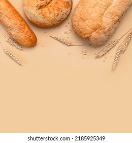 Bread Background. Fresh White Wheat Bread, Round Classic, Ciabatta, French Baguette, Wheat Ears And Grains On Beige Background Flat Lay Top View. Bread Making, Bakery, Healthy Food. Light Mockup