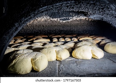 Bread being baked in traditional kiln or oven - Shutterstock ID 1797167503