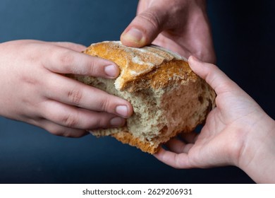 Bread breaking concept - hands with bread