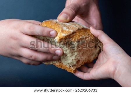Bread breaking concept - hands with bread