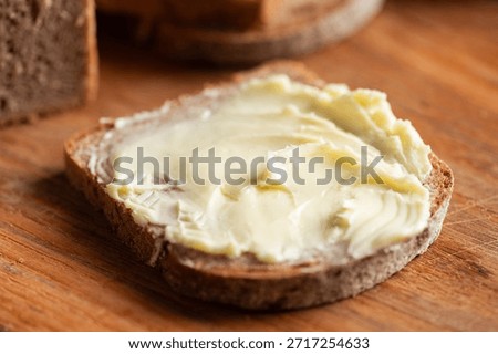 Bread and butter. Closeup view slice of rye bread spreaded with butter
