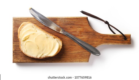 Bread With Butter On Wooden Cutting Board, Top View