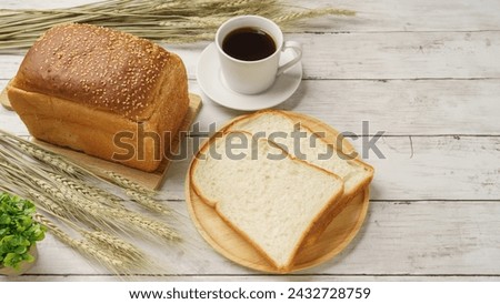 Bread, coffee, and ears of wheat.