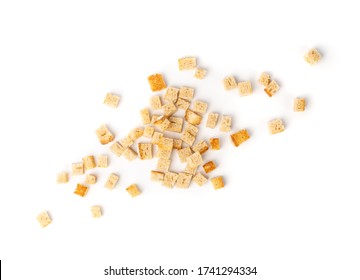 Bread croutons splash isolated on white background top view. Crispy bread cubes, dry crumbs, rusks, crouton or white roasted crackers cube heap