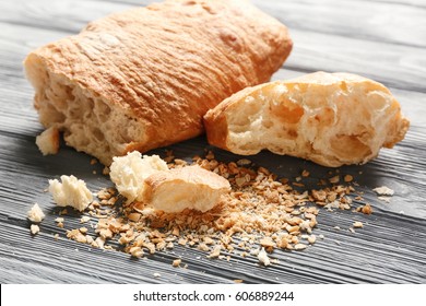 Bread and crumbs on wooden table