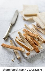 Bread Crust Freshly Cut From Toast Slices On White Wooden Board; Bread Crumbs Preparation