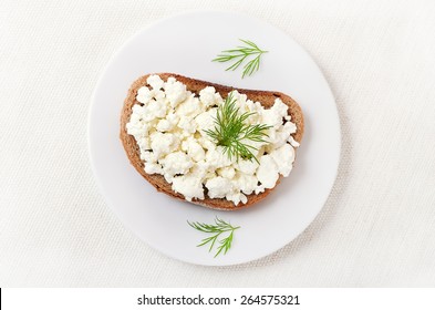 Bread With Curd Cheese And Dill On White Plate, Top View