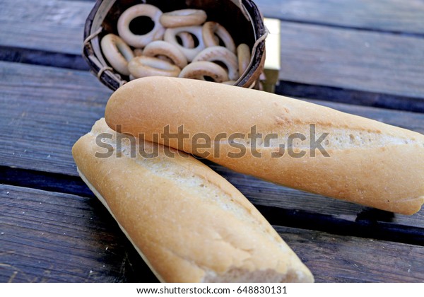Bread is divided into two parts, with bread-rings\
on the table