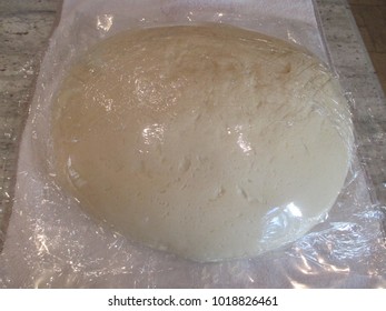 Bread dough wrapped in plastic wrap