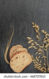 bread and an ear of corn on a dark background