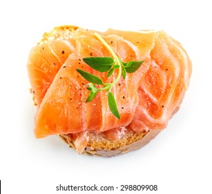 bread with fresh salmon fillet isolated on white background, top view