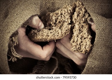bread in the hands of a beggar - Shutterstock ID 79593730