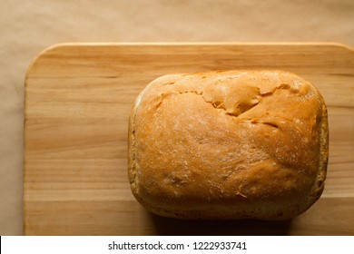 Bread Loaf On Cutting Board With Copy Space. Top Down View.