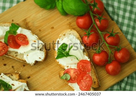 Similar – Image, Stock Photo Bruschetta with cream cheese, cherry tomatoes and basil