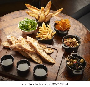 Bread And Nibbles For A Party On Wood Table