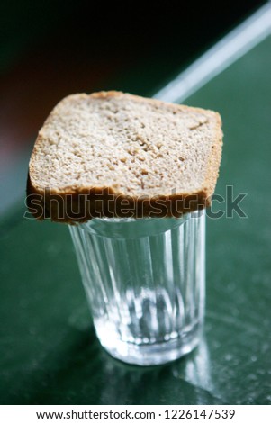 bread on a glass of water ohr vodka, a memory of dead people
